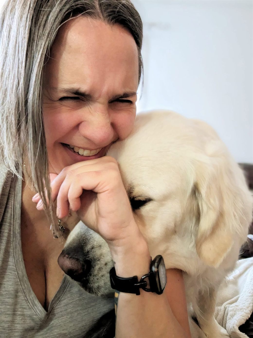Jodene laughing with her eyes closed as Howard nuzzles into her