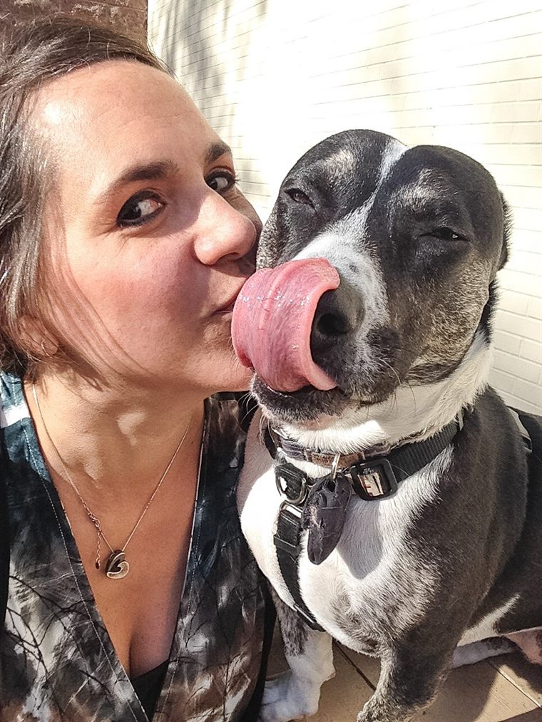 Sammy licking Jodene's face in the sunshine
